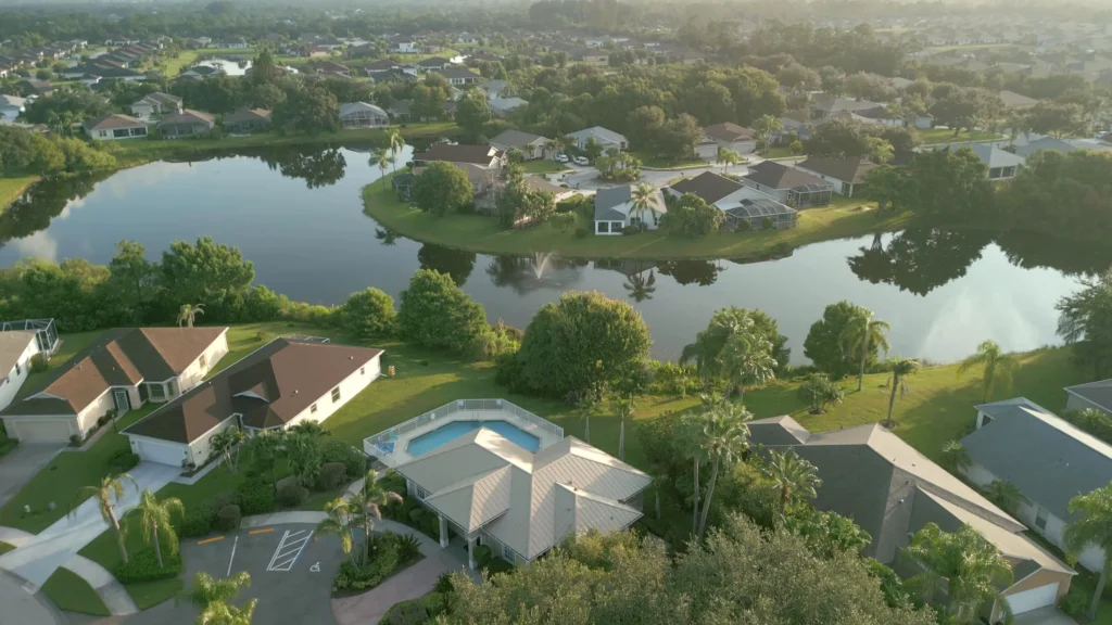 Aerial view of lakeside homes and green common areas in an Indian River County neighborhood