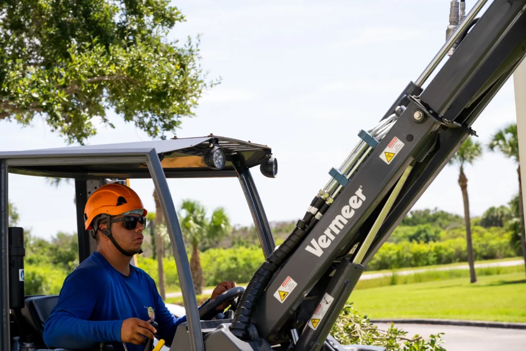 Operator running a compact loader on a job site