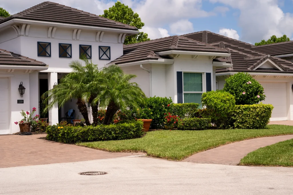 Home with a curved driveway and layered landscape beds